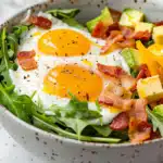 Bacon and egg comfort keto breakfast bowl with cheddar and arugula - 248 calories, 25g protein
