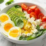 Mediterranean keto breakfast bowl with eggs, feta, avocado, and spinach - 238 calories, 24g protein