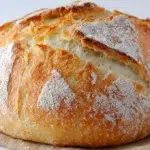 Rustic basic sourdough bread loaf with a golden crust and airy crumb, freshly baked and sliced