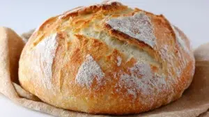 Rustic basic sourdough bread loaf with a golden crust and airy crumb, freshly baked and sliced