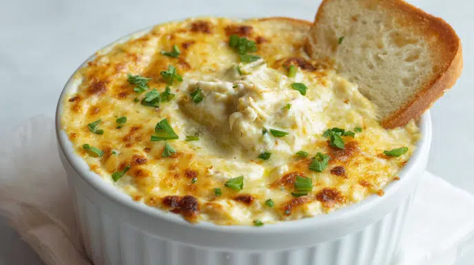 Creamy hot crab dip baked with melted cheese and tender crab meat, served with crackers