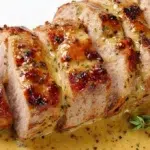 Honey mustard pork tenderloin glazed and roasted until juicy with a golden caramelized crust