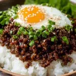 Korean ground beef bowl with seasoned beef served over rice and topped with green onions and sesame seeds