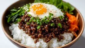 Korean ground beef bowl with seasoned beef served over rice and topped with green onions and sesame seeds