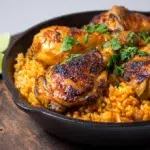 Peri peri chicken and rice served with juicy spiced chicken, fluffy rice, and vibrant peri peri sauce