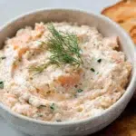 Smoked salmon dip served creamy with herbs and lemon, paired with crackers