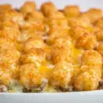 Tater Tot Casserole baked with seasoned ground beef, creamy sauce, melted cheese, and crispy golden tater tots on top